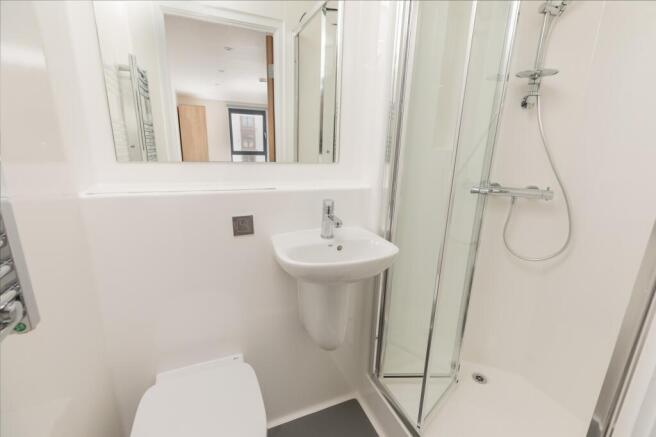 A modern and pristine bathroom featuring a slee...