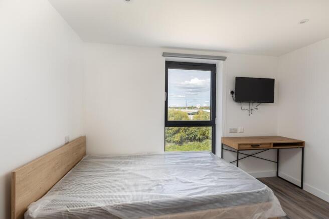 A bright and spacious double bedroom featuring ...