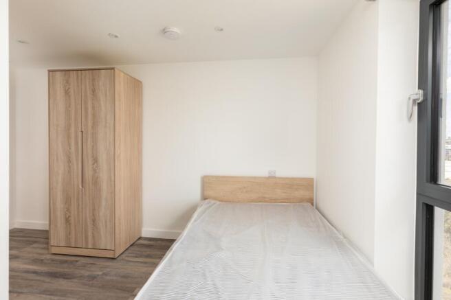 A bright and spacious double bedroom featuring ...