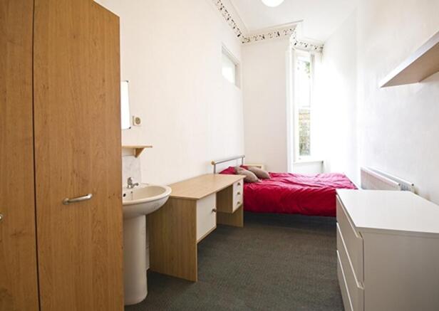 A bright and inviting double bedroom featuring ...