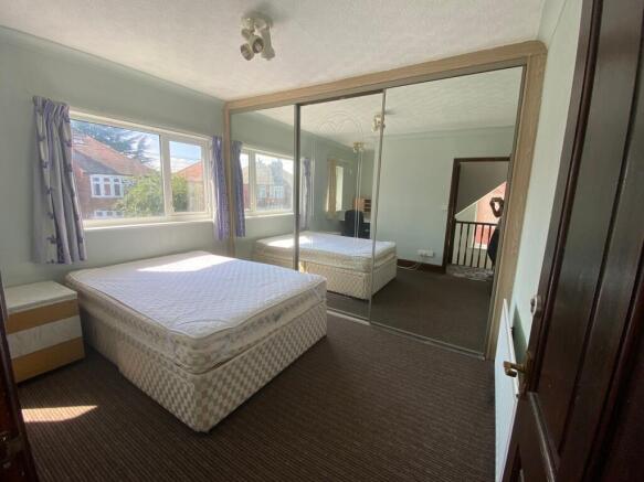A spacious and well-lit double bedroom featurin...