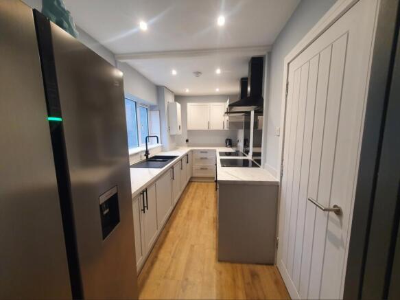 This modern kitchen features sleek cabinetry an...