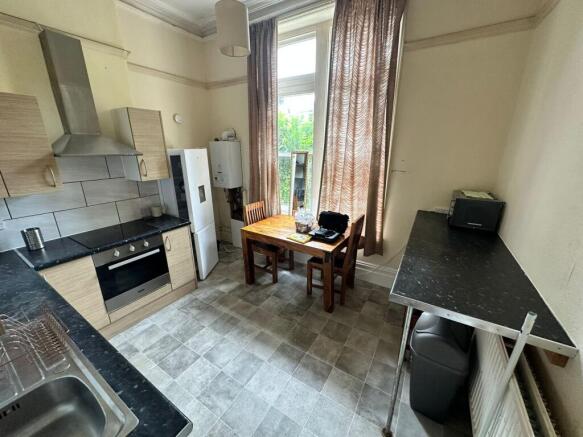 A spacious and well-lit kitchenette with modern...