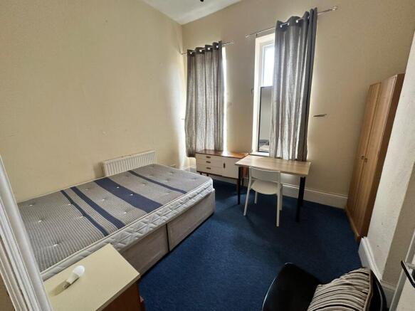 A cozy and well-arranged double bedroom featuri...