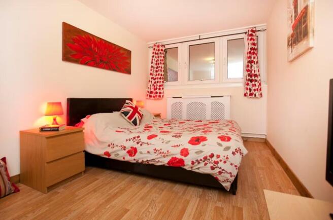 A vibrant and cozy double bedroom featuring bri...