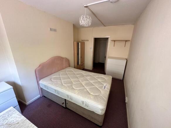 A spacious and inviting double bedroom featurin...