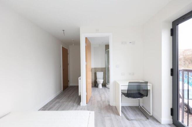 A bright and spacious double bedroom featuring ...