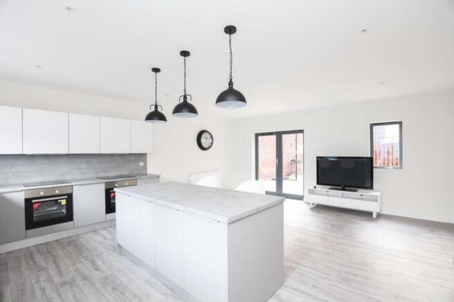 A spacious and modern kitchen with ample natura...