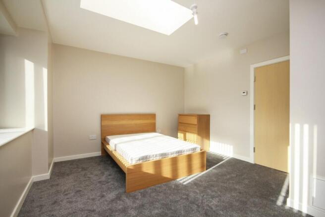 A bright and spacious double bedroom featuring ...