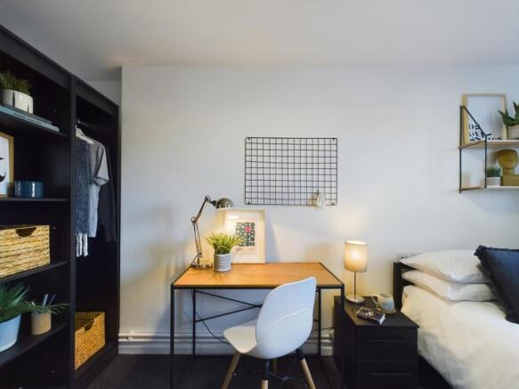 A bright and stylish double bedroom featuring a...