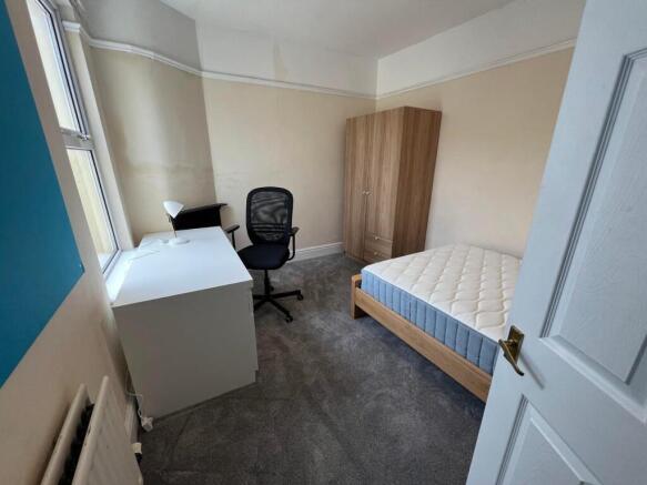 A bright and tidy double bedroom featuring a co...