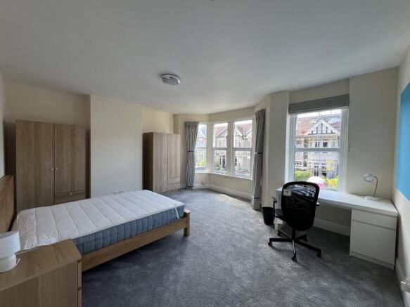 Bright and spacious master bedroom featuring a ...
