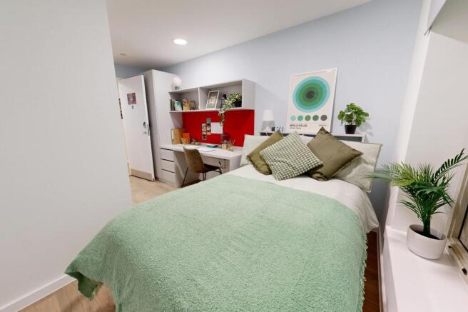 This inviting double bedroom features a comfort...