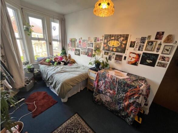 A cozy double bedroom filled with character, na...