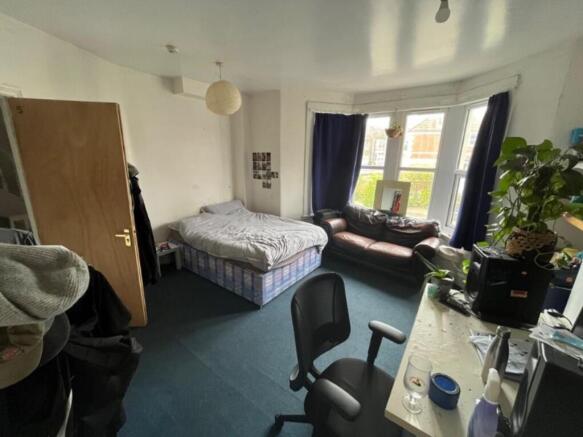 A cozy double bedroom with ample natural light ...