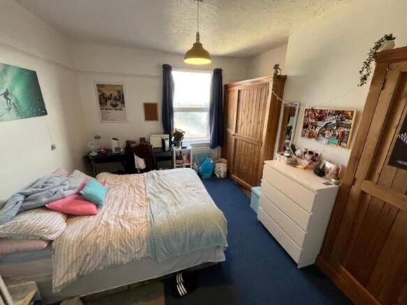 A cozy and inviting double bedroom with ample s...