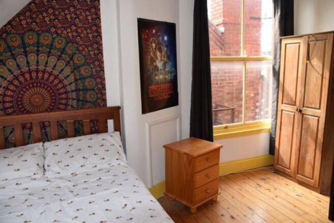 A bright and inviting double bedroom featuring ...
