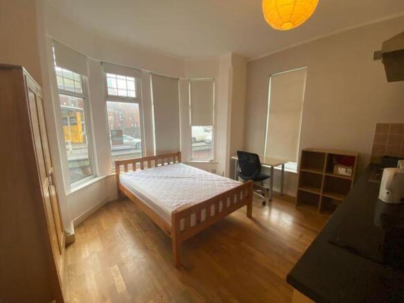 A spacious and bright double bedroom, featuring...