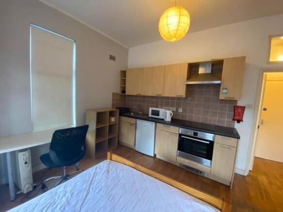 A modern kitchenette with ample space and natur...