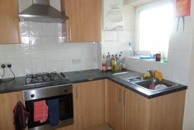A functional kitchenette with ample storage and...