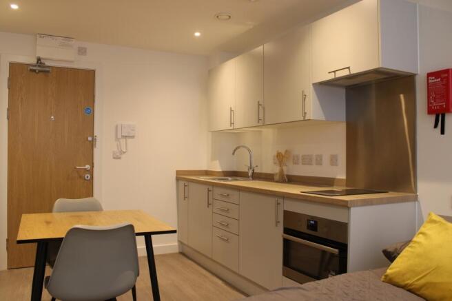 A modern and clean kitchenette featuring ample ...