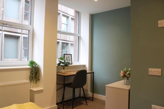 A bright and inviting double bedroom featuring ...
