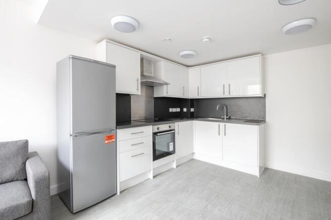 A modern and tidy kitchenette with sleek applia...