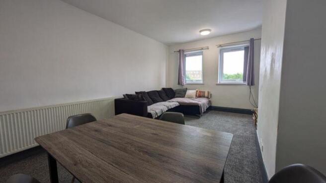 A spacious and inviting modern living room, per...