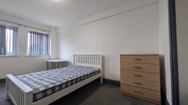 A bright and inviting double bedroom with ample...