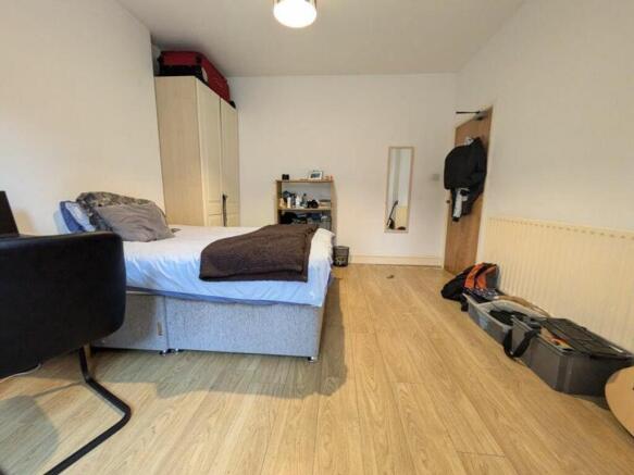 A spacious and inviting double bedroom with nat...