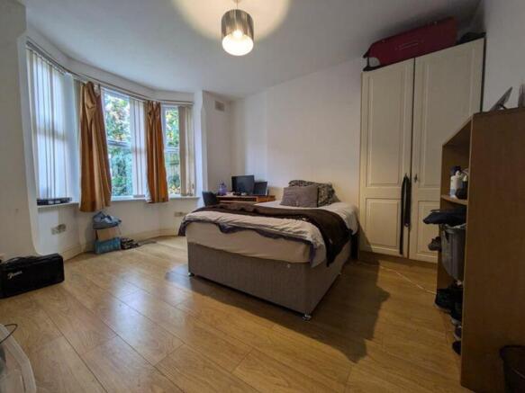 A bright and spacious double bedroom with ample...