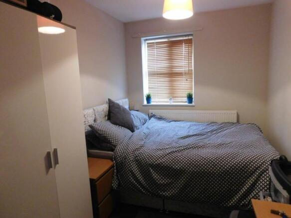 A cozy and inviting double bedroom with ample n...
