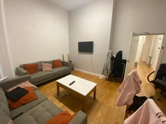 A spacious and well-lit modern living room perf...