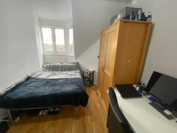 A bright and tidy double bedroom with ample sto...