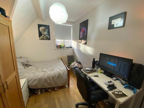 A cozy and well-lit double bedroom featuring a ...