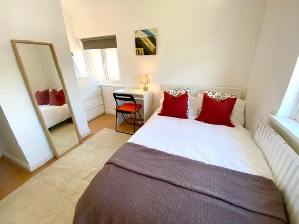 A bright and inviting double bedroom featuring ...