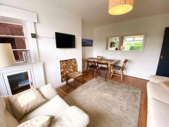 A bright and inviting living room with a cozy a...
