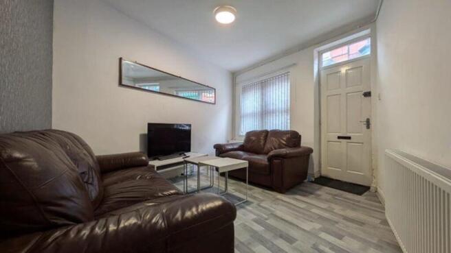 A bright and inviting living room featuring com...