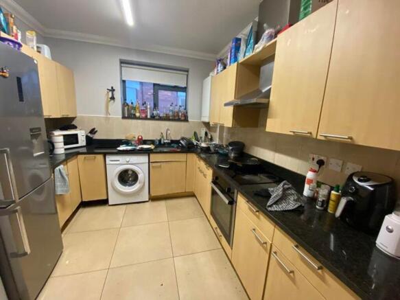 A spacious kitchen equipped with modern applian...