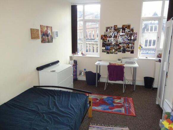 A bright and inviting double bedroom featuring ...