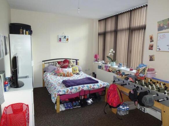 A cozy double bedroom with ample natural light ...