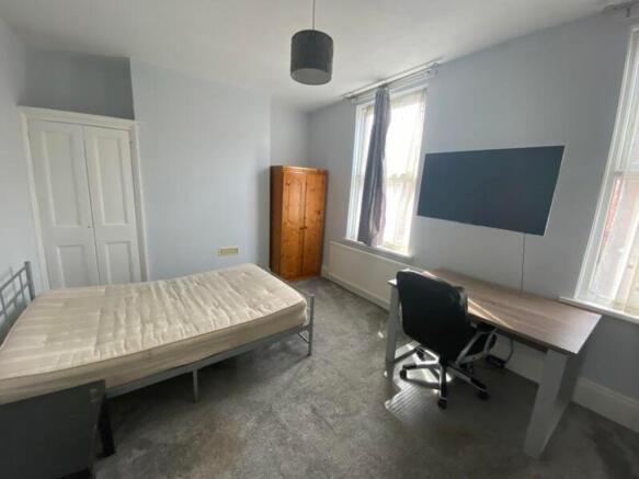 A spacious and bright double bedroom featuring ...
