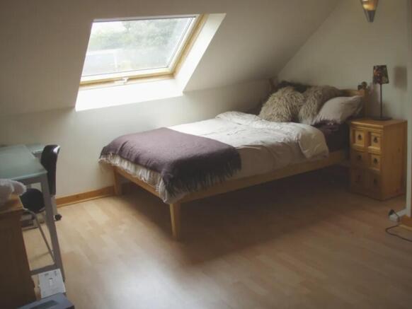 A bright and inviting double bedroom with ample...