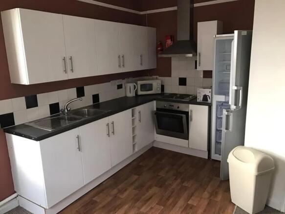 A modern kitchenette with ample storage and ess...