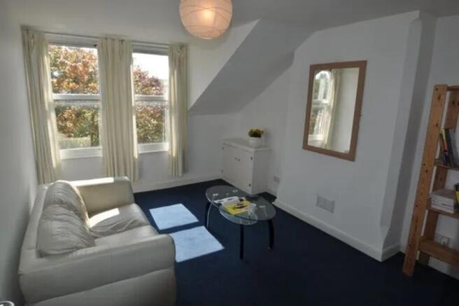 A bright and inviting living room with ample na...