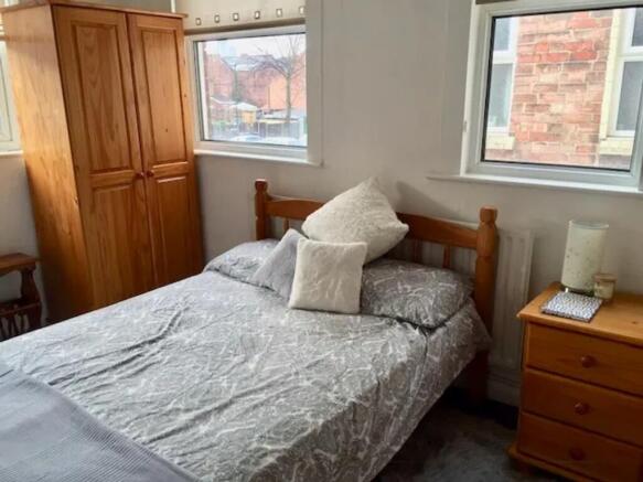 A bright and inviting double bedroom featuring ...