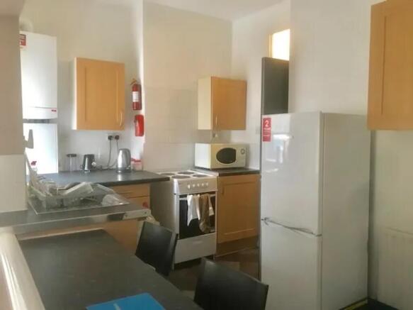 A bright and tidy kitchenette with modern appli...