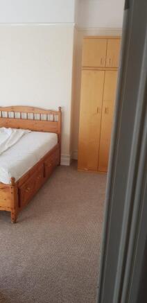 A cozy double bedroom featuring ample storage a...