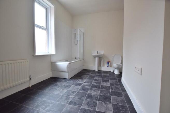 A spacious and bright bathroom featuring both a...