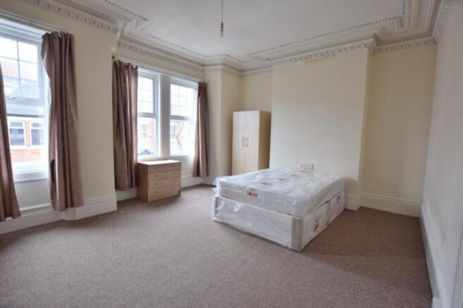 A spacious and bright double bedroom with large...